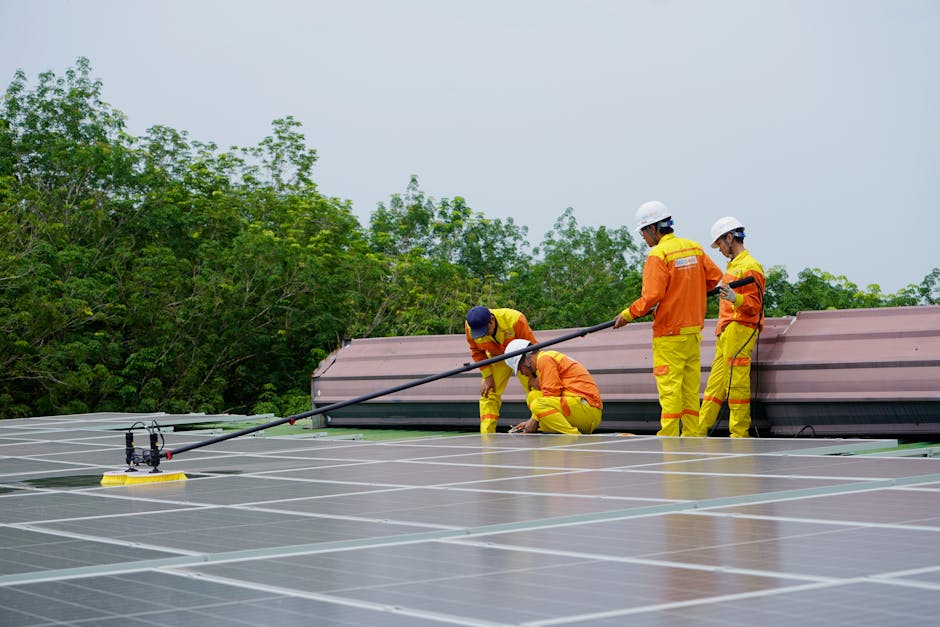 A team of workers cleaning solar panels on a sunny day, focusing on renewable energy maintenance.